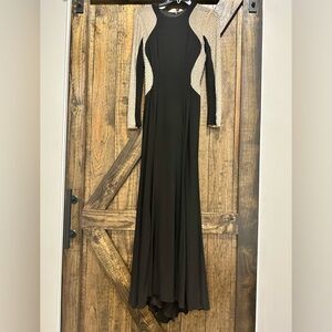 Black formal gown with sheer, cream long sleeves. Size 6P.